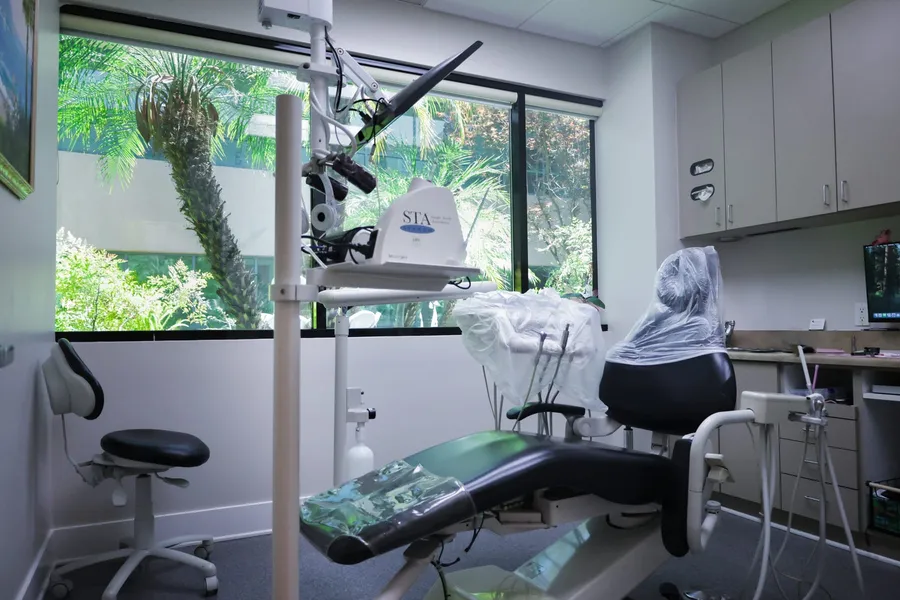 A treatment room at Thousand Oaks Family Dentistry, looking out through a window onto the garden